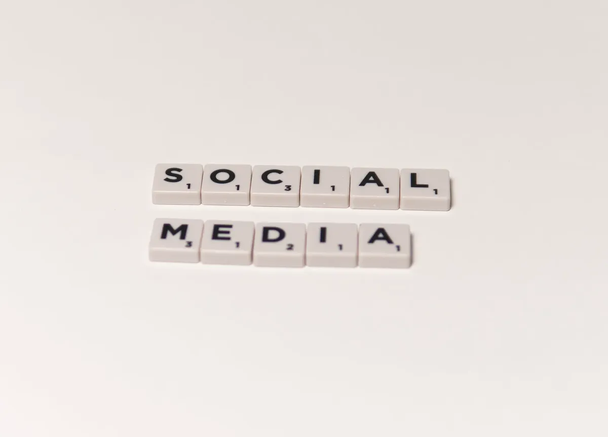 Scrabble tiles spelling 'social media' on a white background, representing digital communication concepts.