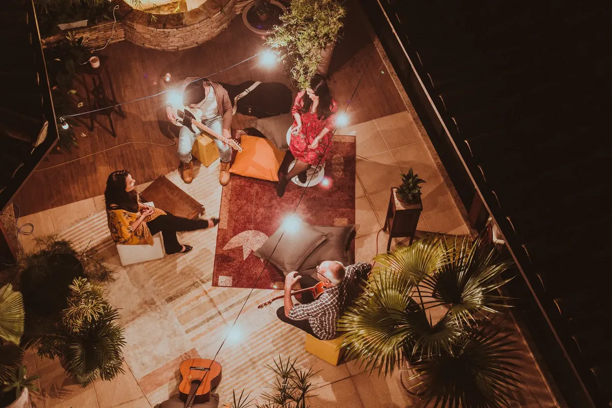 Aerial view of a group enjoying music in a cozy setting at night.