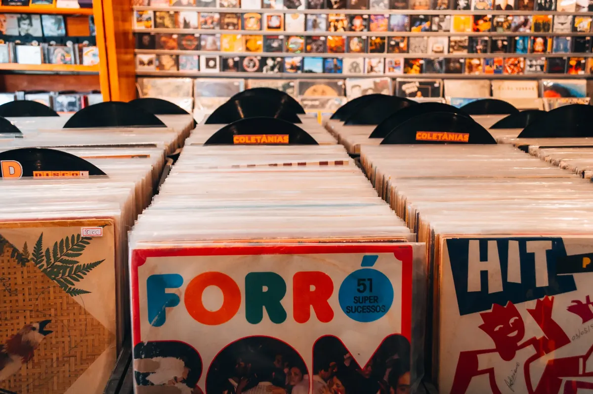 Rows of vintage vinyl records in a Brazilian music store, showcasing classic album art and retro vibes.